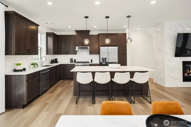 a kitchen with a sink and chairs