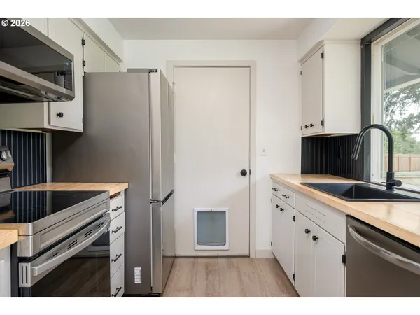 a kitchen with kitchen island a counter space a sink and a refrigerator