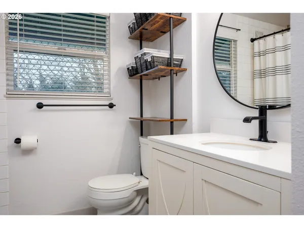 a bathroom with a sink a toilet and a mirror