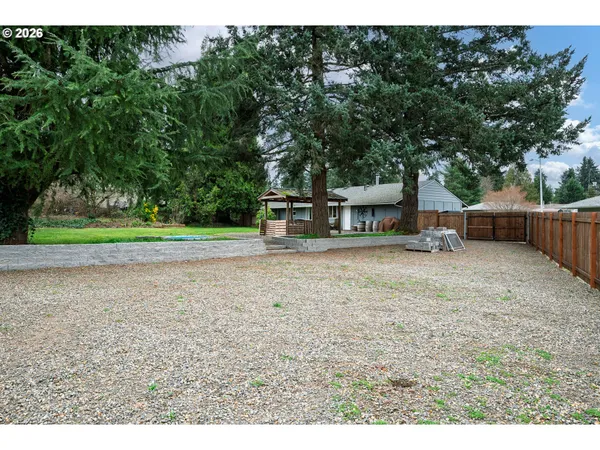 a backyard of a house with barbeque oven