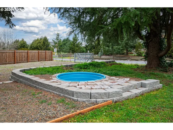 a view of a backyard with large tree