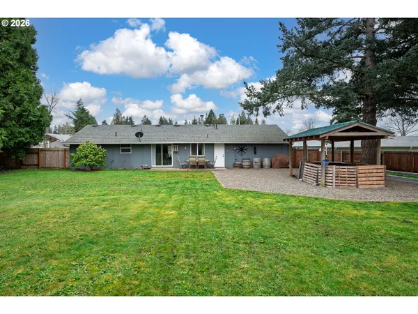 a view of a house with a backyard