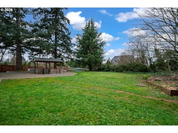 a view of a house with backyard and a sitting area