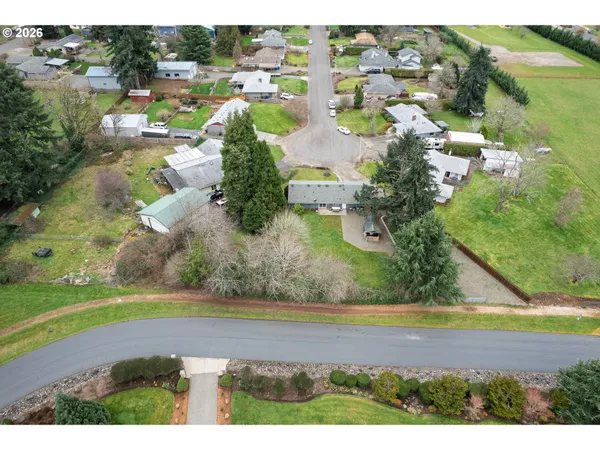 an aerial view of residential houses with outdoor space and street view