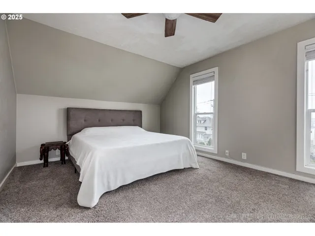 a bed sitting in a bedroom next to a window