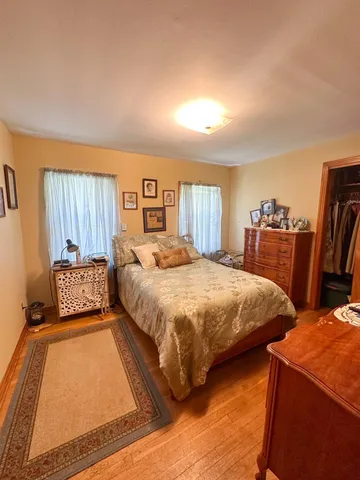 a bedroom with double bed and a couch