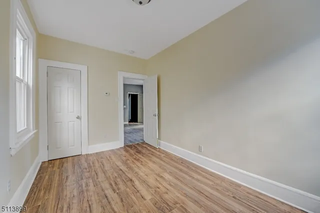 a view of an empty room and wooden floor