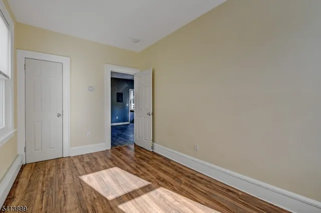 a view of an empty room and wooden floor