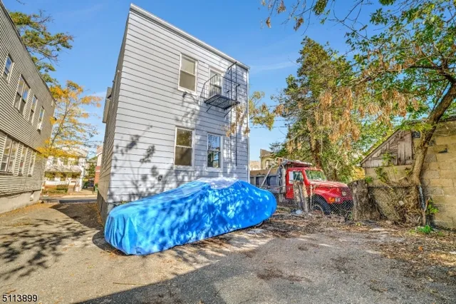 a view of a chairs and table in the backyard