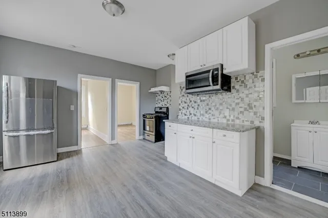a kitchen with stainless steel appliances wooden cabinets and granite counter tops