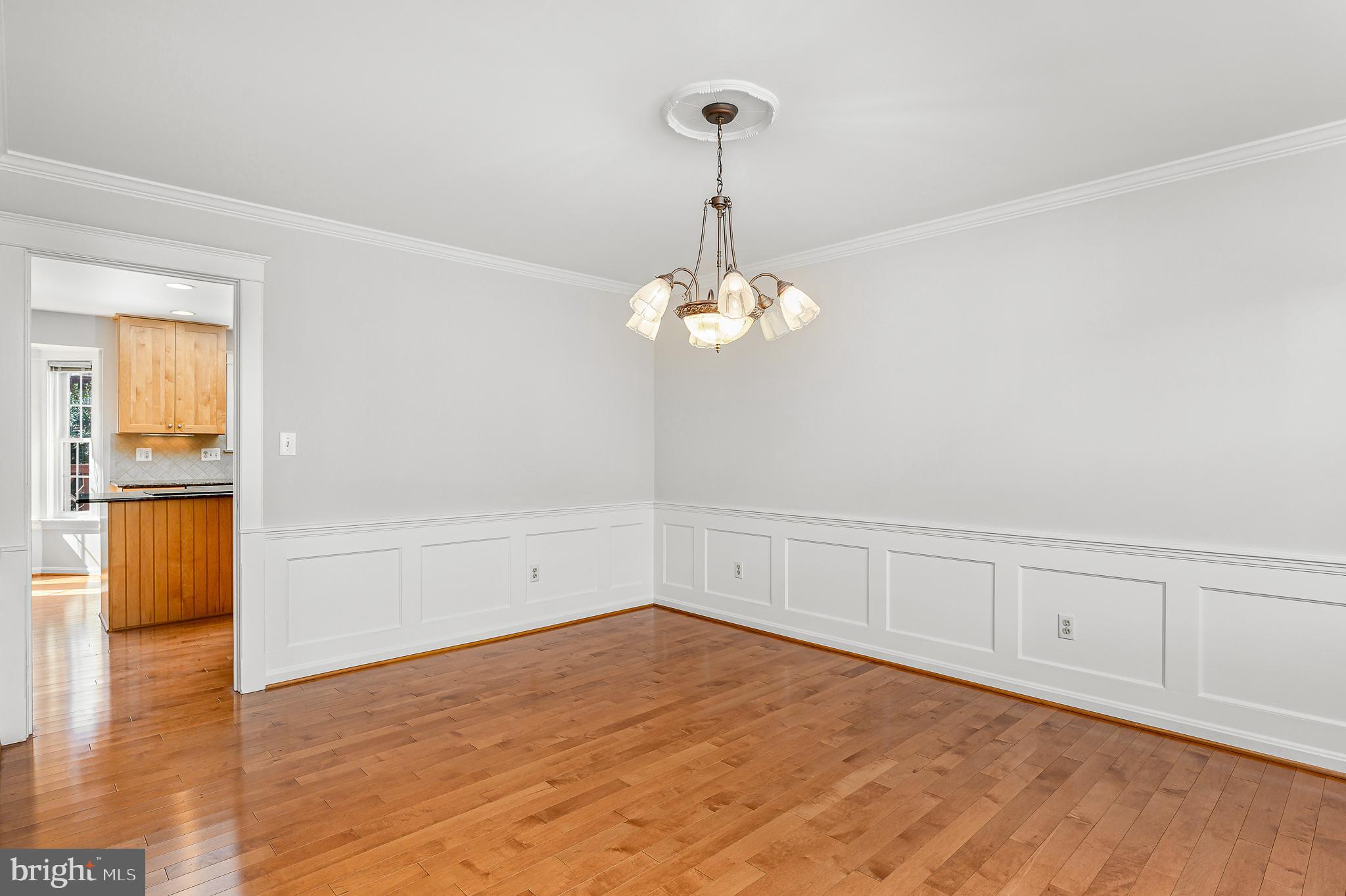 43356 Wayside Circle Ashburn, VA 20147 - Photo 12 of 52 a view of an empty room with wooden floor and kitchen