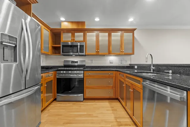 a kitchen with stainless steel appliances granite countertop a stove and a sink