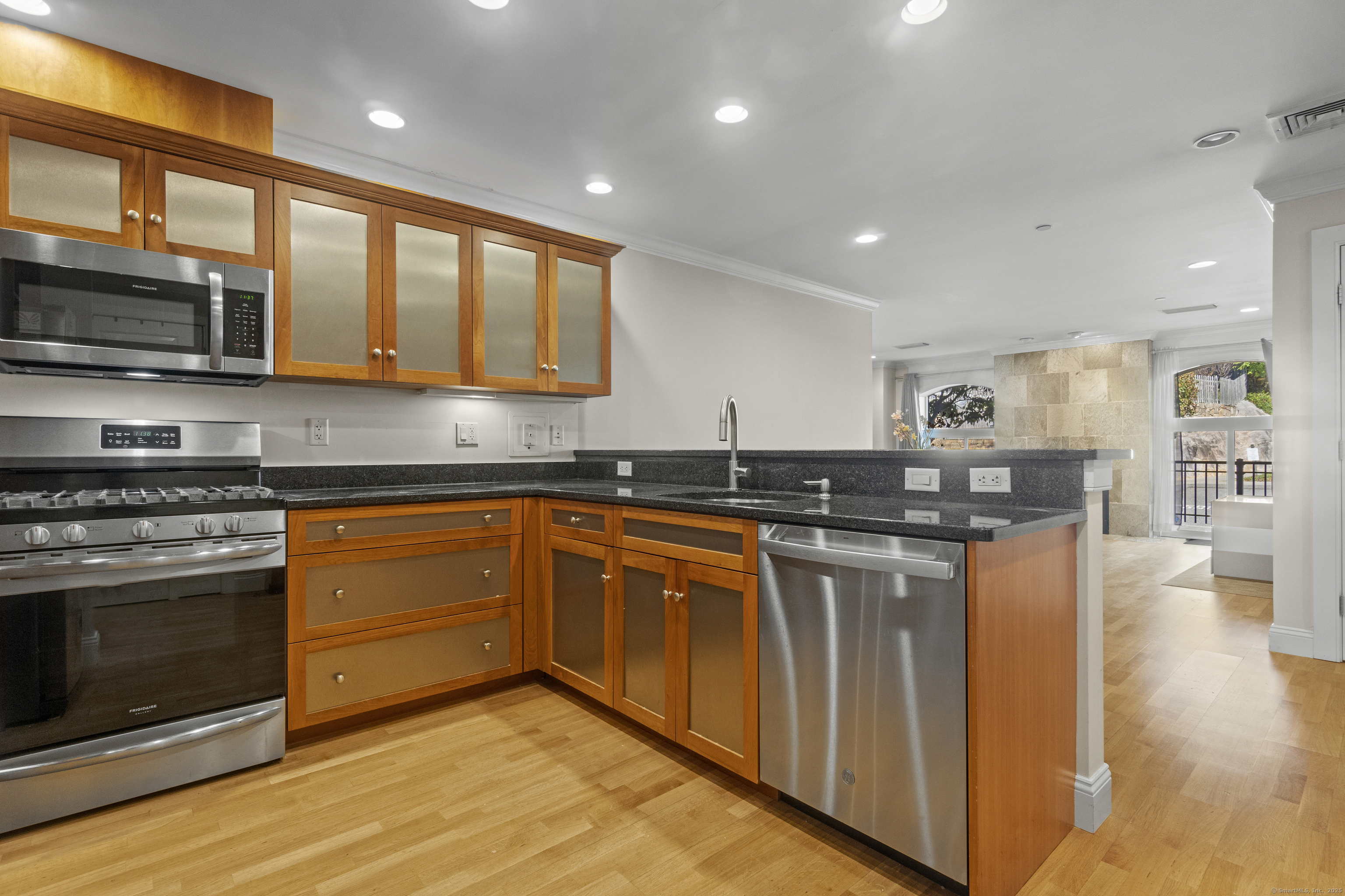 17 Water Street, Unit A10 Groton, CT 06355 - Photo 12 of 35 a kitchen with stainless steel appliances granite countertop a stove and a sink