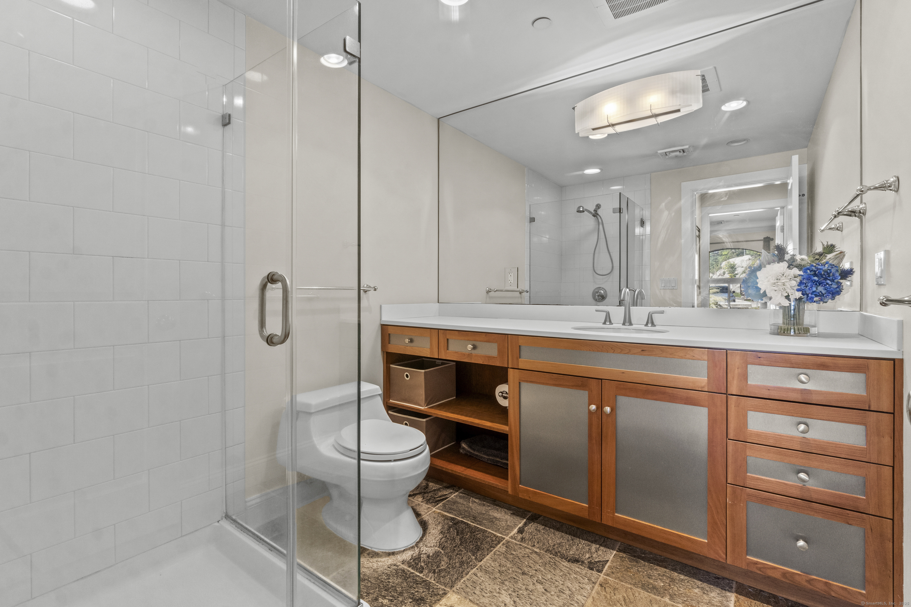 17 Water Street, Unit A10 Groton, CT 06355 - Photo 16 of 35 a spacious bathroom with a double vanity sink a mirror and a toilet