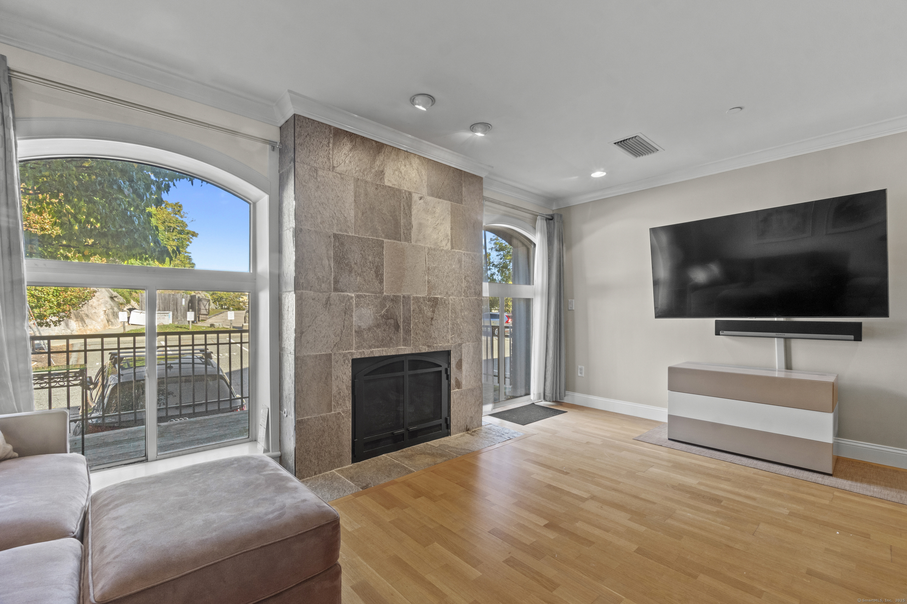 17 Water Street, Unit A10 Groton, CT 06355 - Photo 6 of 35 a living room with fireplace furniture and a flat screen tv
