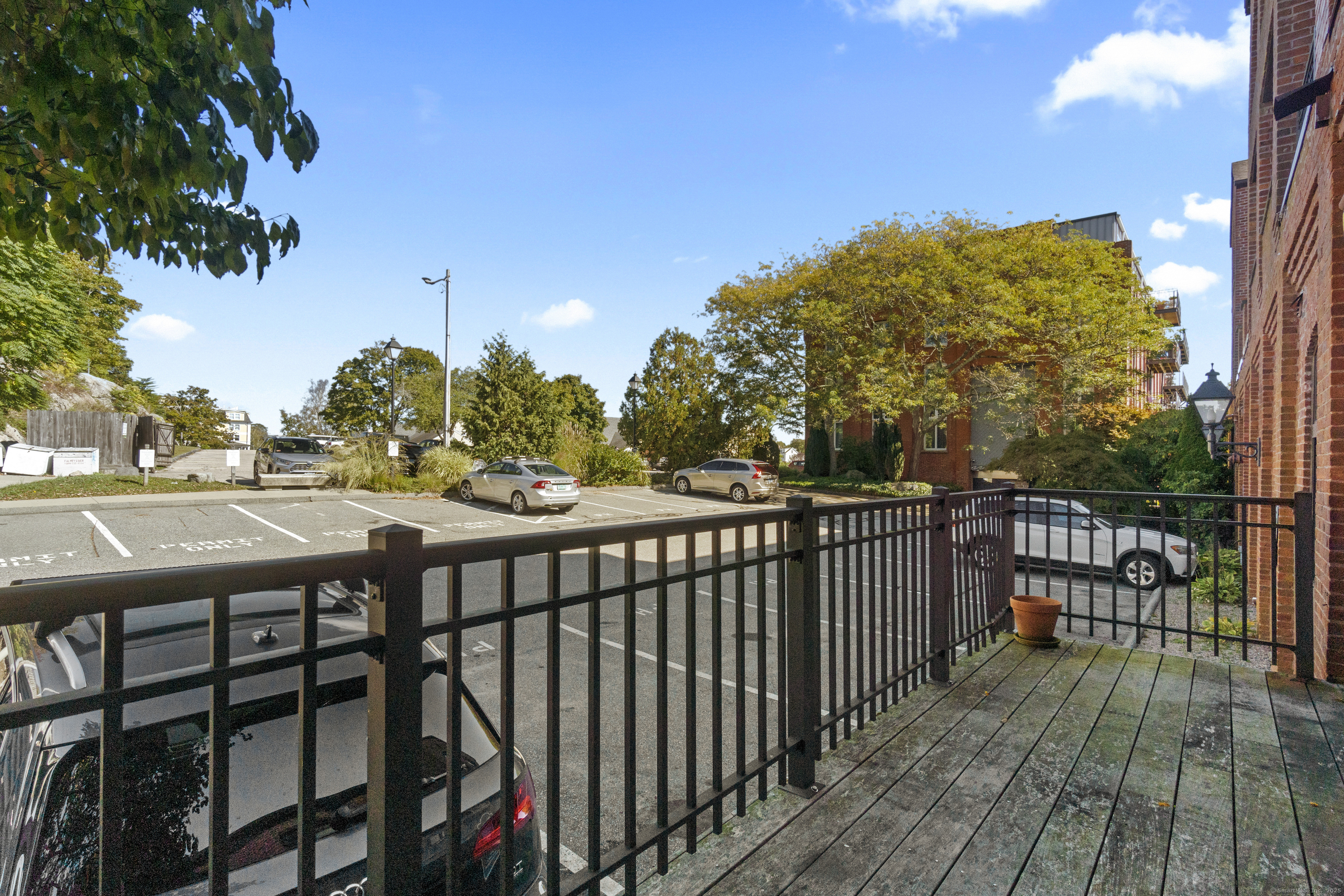 17 Water Street, Unit A10 Groton, CT 06355 - Photo 7 of 35 a view of a balcony with wooden floor and fence