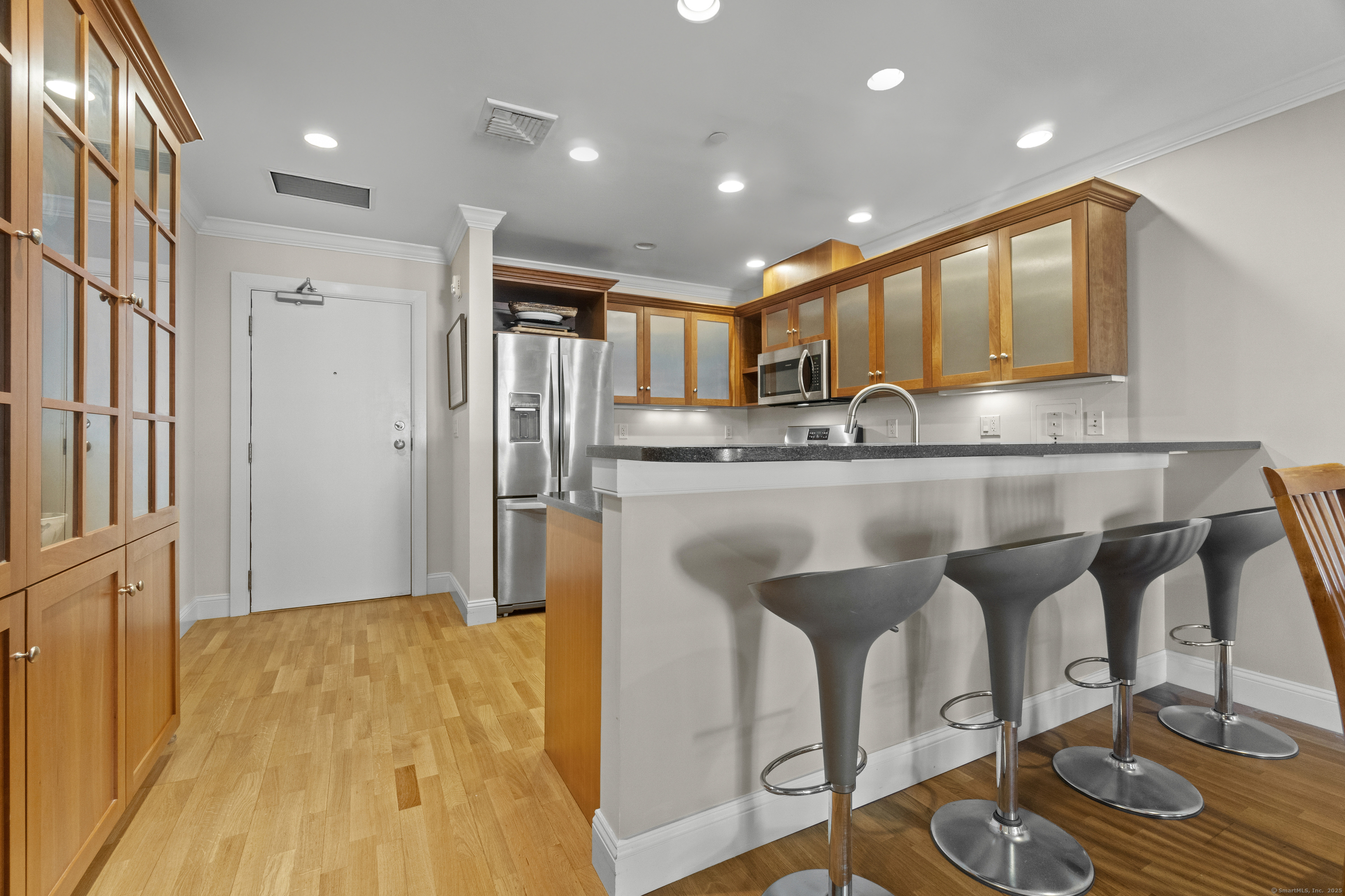 17 Water Street, Unit A10 Groton, CT 06355 - Photo 8 of 35 a kitchen with stainless steel appliances granite countertop a refrigerator and a stove top oven