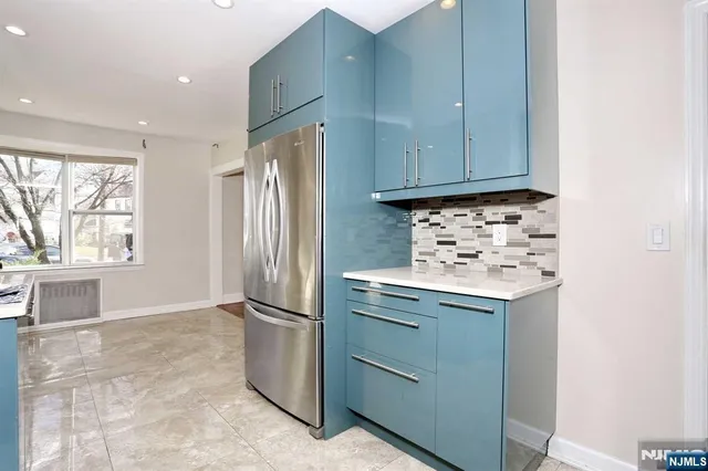 a kitchen with a refrigerator and a sink