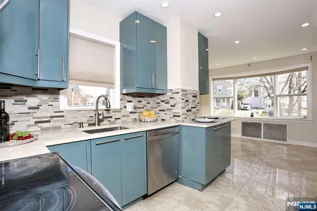 a kitchen with stainless steel appliances granite countertop a sink stove and cabinets