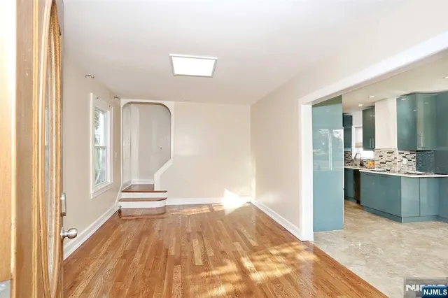 a view of a bedroom with wooden floor and a bathroom