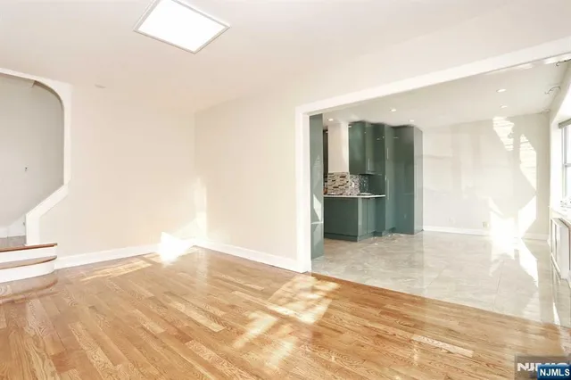an empty room with cabinet and mirrors