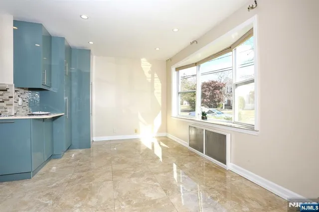 a view of a kitchen with a sink and dishwasher a fireplace with wooden floor