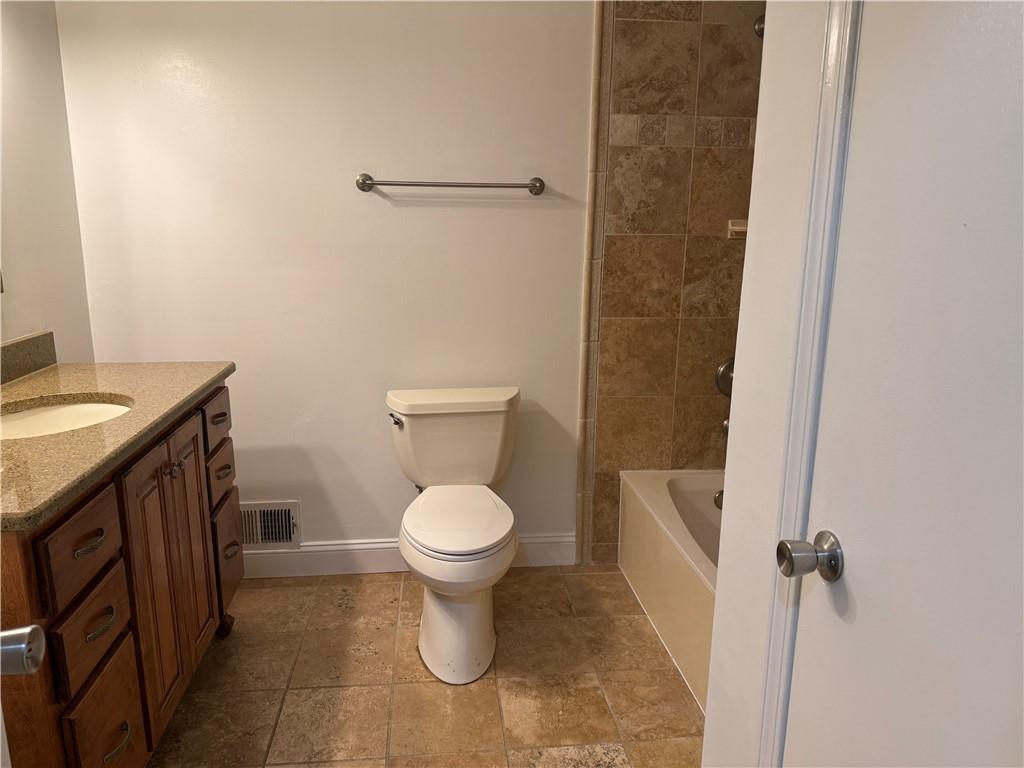 7719 Glen Devon Road Jonesboro, GA 30236 - Photo 14 of 37 a white toilet sitting next to a bathroom sink