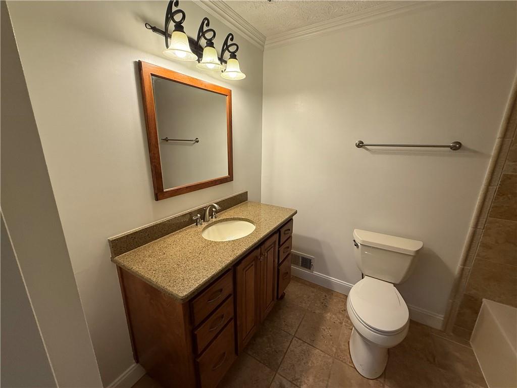 7719 Glen Devon Road Jonesboro, GA 30236 - Photo 15 of 37 a bathroom with a toilet sink and mirror
