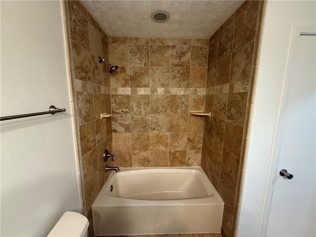 7719 Glen Devon Road Jonesboro, GA 30236 - Photo 16 of 37 a bathroom with a tub and a shower
