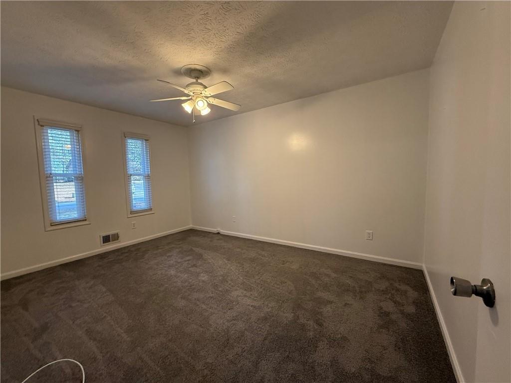 7719 Glen Devon Road Jonesboro, GA 30236 - Photo 19 of 37 an empty room with windows and fan