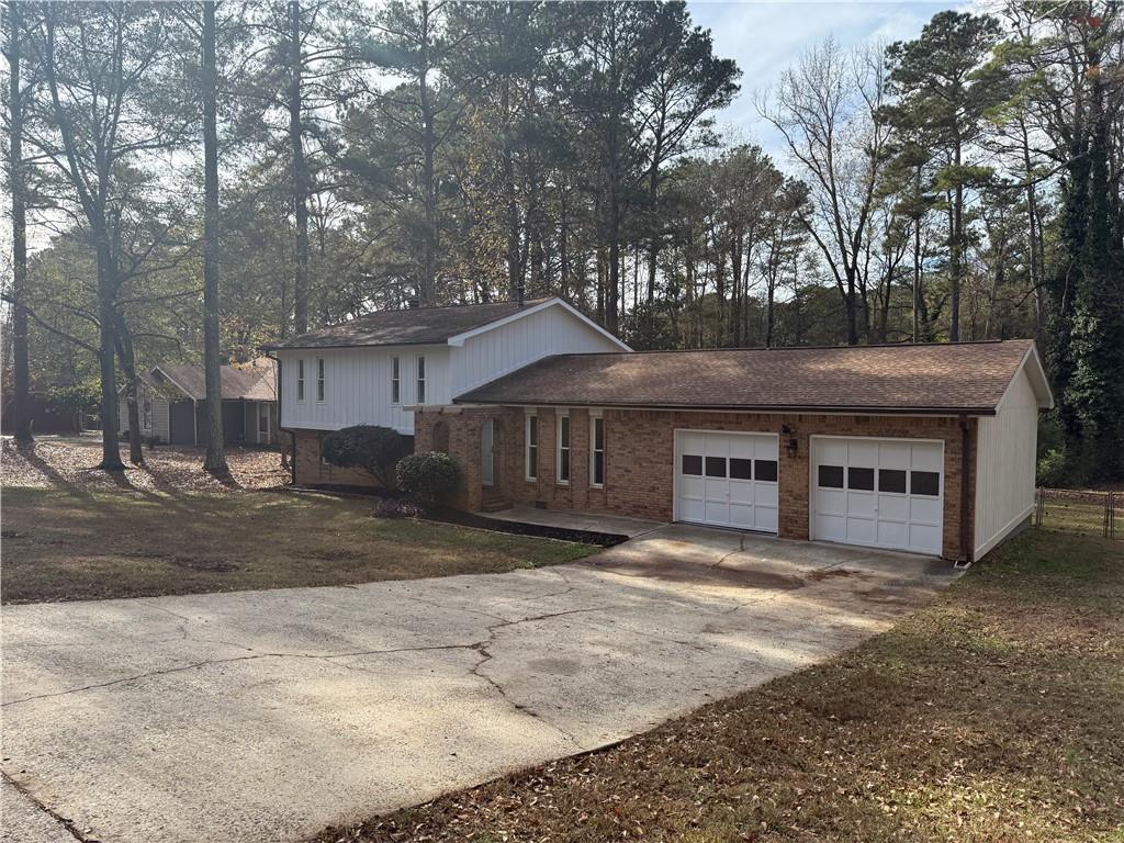 7719 Glen Devon Road Jonesboro, GA 30236 - Photo 2 of 37 a front view of a house with a yard and garage
