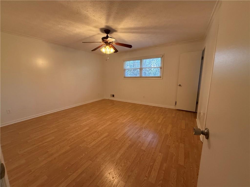 7719 Glen Devon Road Jonesboro, GA 30236 - Photo 21 of 37 an empty room with a chandelier fan and windows