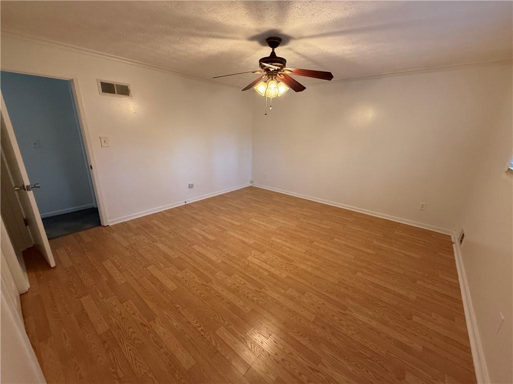 7719 Glen Devon Road Jonesboro, GA 30236 - Photo 22 of 37 an empty room with a chandelier fan and a window