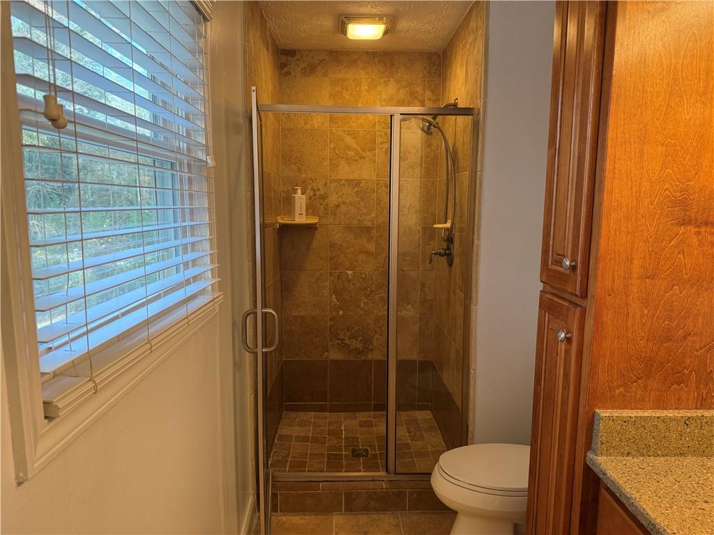 7719 Glen Devon Road Jonesboro, GA 30236 - Photo 24 of 37 a bathroom with a shower and a toilet
