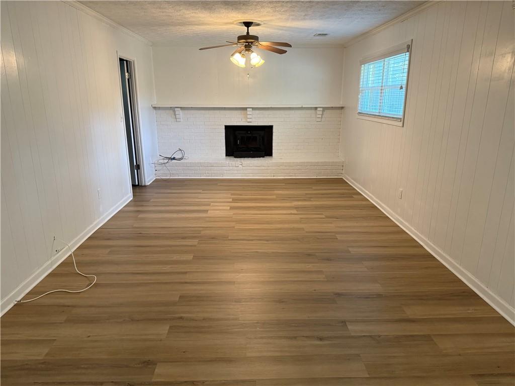 7719 Glen Devon Road Jonesboro, GA 30236 - Photo 25 of 37 a view of an empty room with wooden floor and a ceiling fan