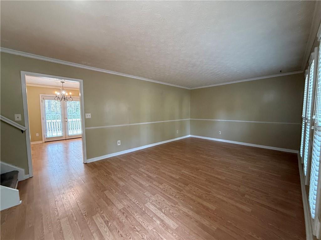 7719 Glen Devon Road Jonesboro, GA 30236 - Photo 6 of 37 an empty room with wooden floor and windows