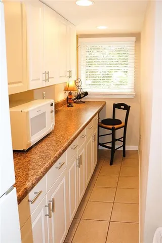 a bathroom with a granite countertop sink and a bathtub