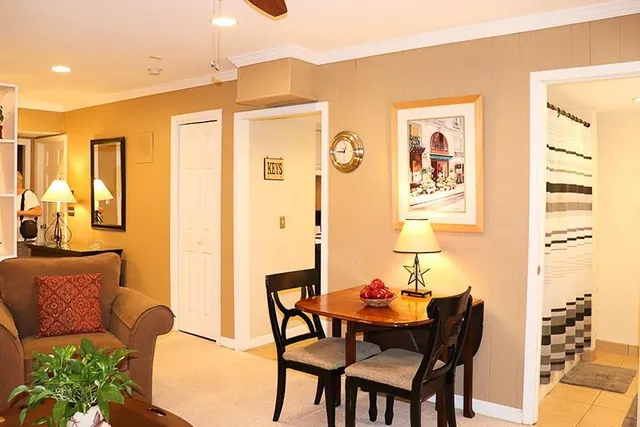 a dining room with furniture and wooden floor