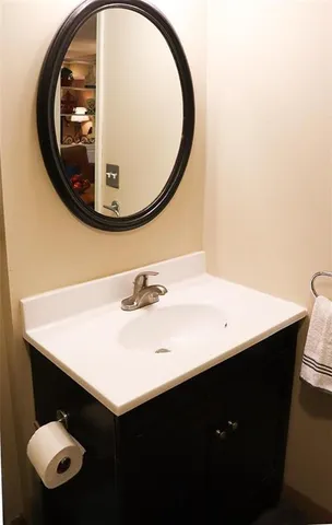 a bathroom with a sink mirror and vanity