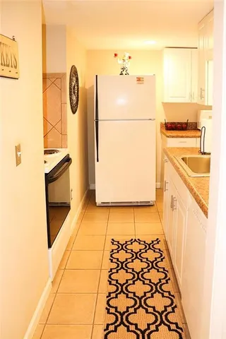 a kitchen with a refrigerator and a stove