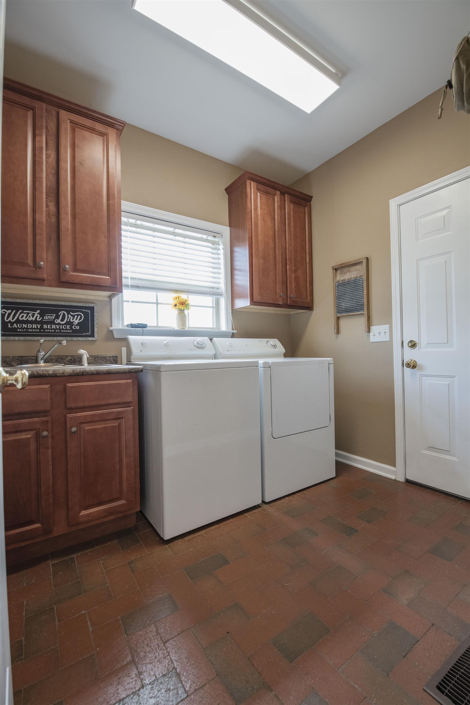 10600 Taylor Road Rockvale, TN 37153 - Photo 11 of 30 The utility room has extra cabinets, sink and brick flooring! 10600 Taylor Rd, Rockvale, TN 37153