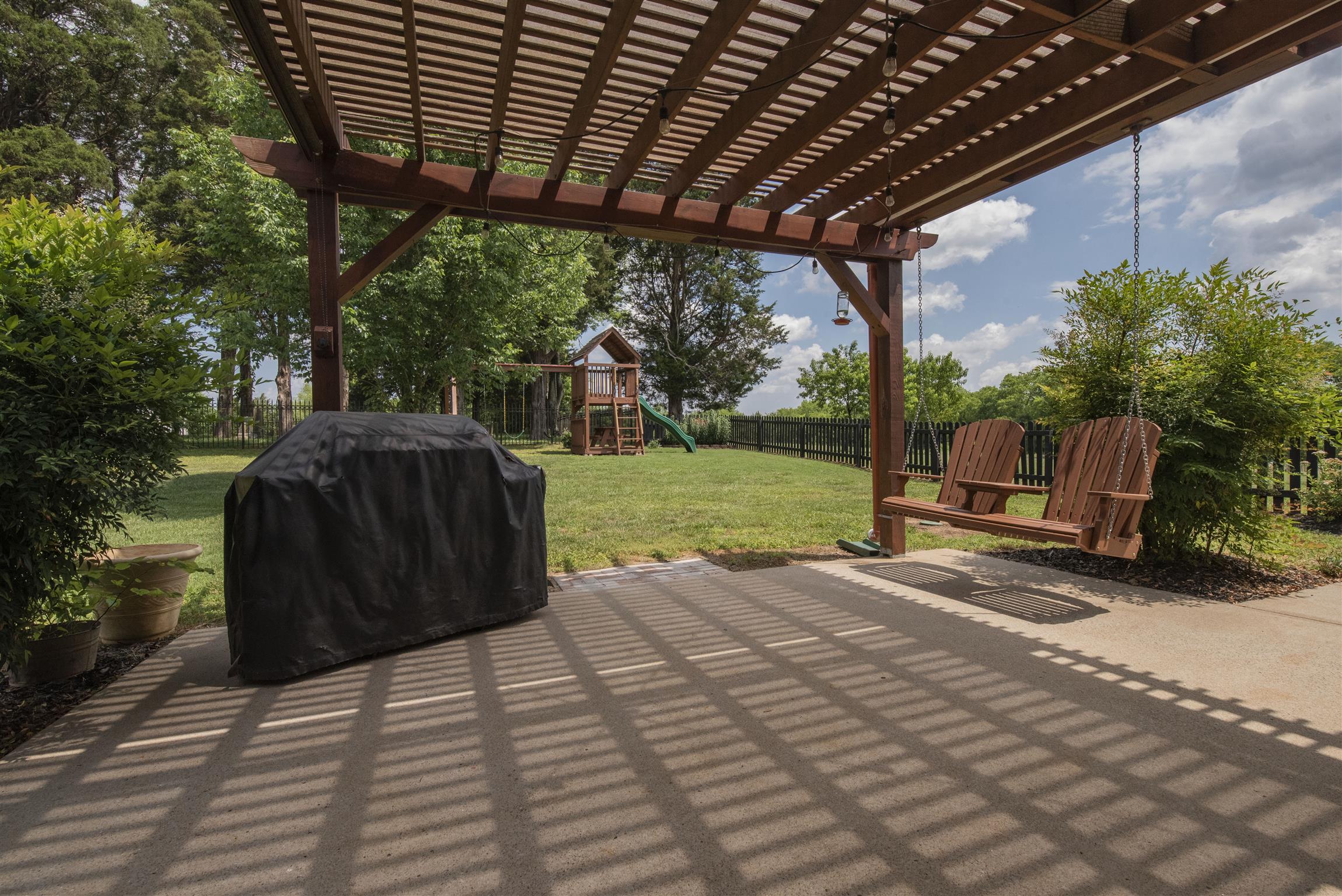 10600 Taylor Road Rockvale, TN 37153 - Photo 21 of 30 This extra large back patio with pergola and swing is perfect for grilling and outdoor entertaining! 10600 Taylor Rd, Rockvale, TN 37153