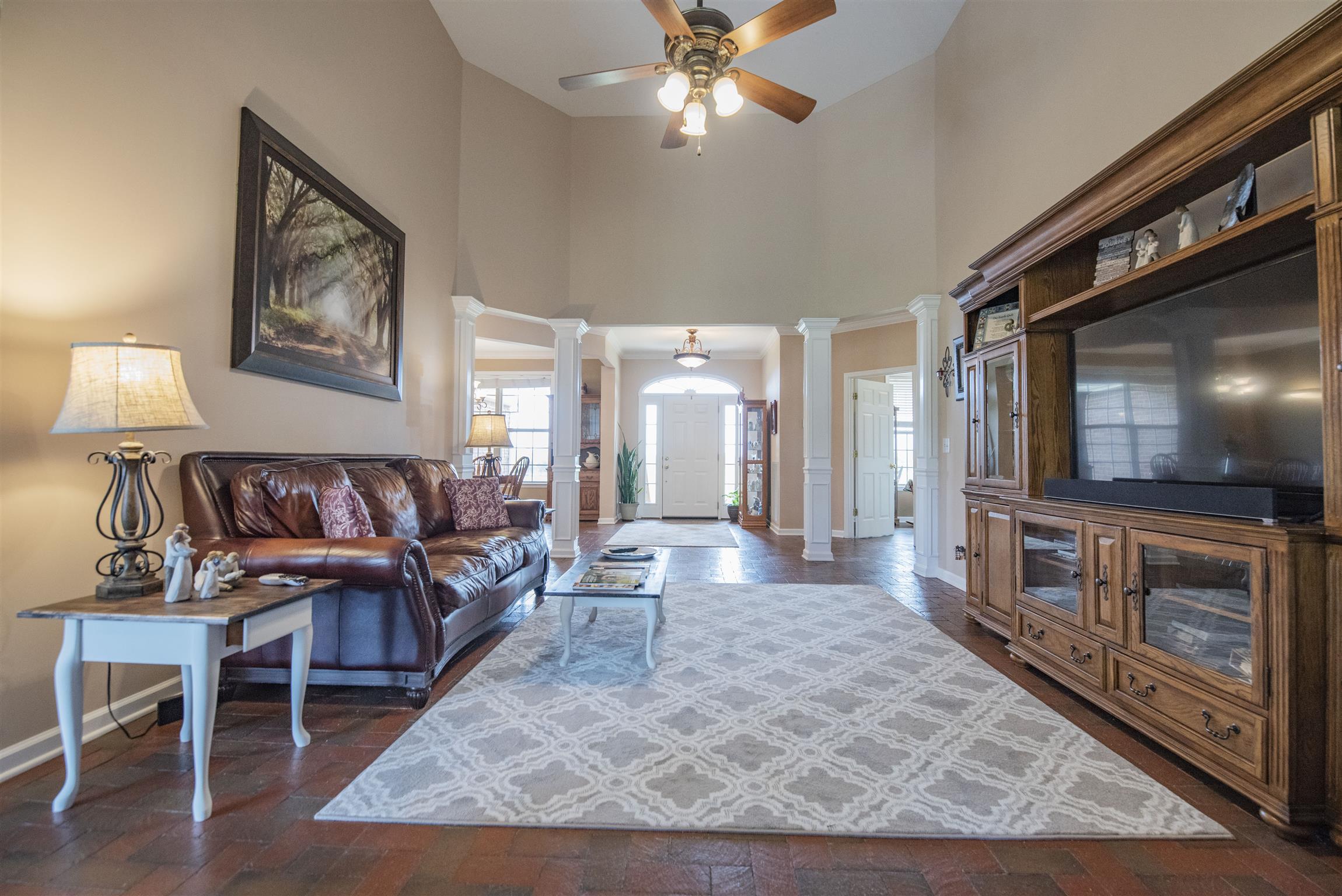 10600 Taylor Road Rockvale, TN 37153 - Photo 6 of 30 Notice the high ceiling with ceiling fan, brick flooring and neutral colors in this lovely living room! 10600 Taylor Rd, Rockvale, TN 37153