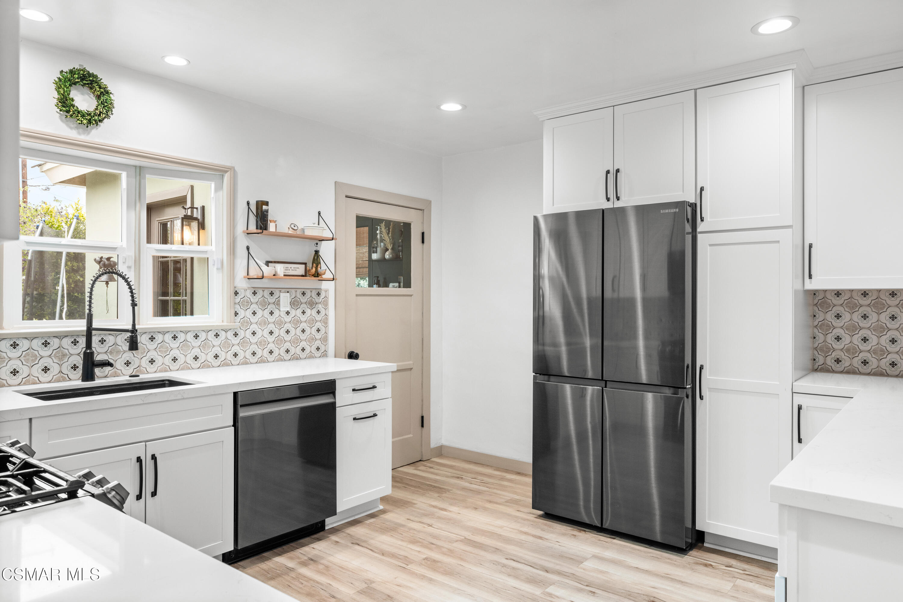 4391 Adam Road Simi Valley, CA 93063 - Photo 13 of 30 a kitchen with a refrigerator sink and cabinets