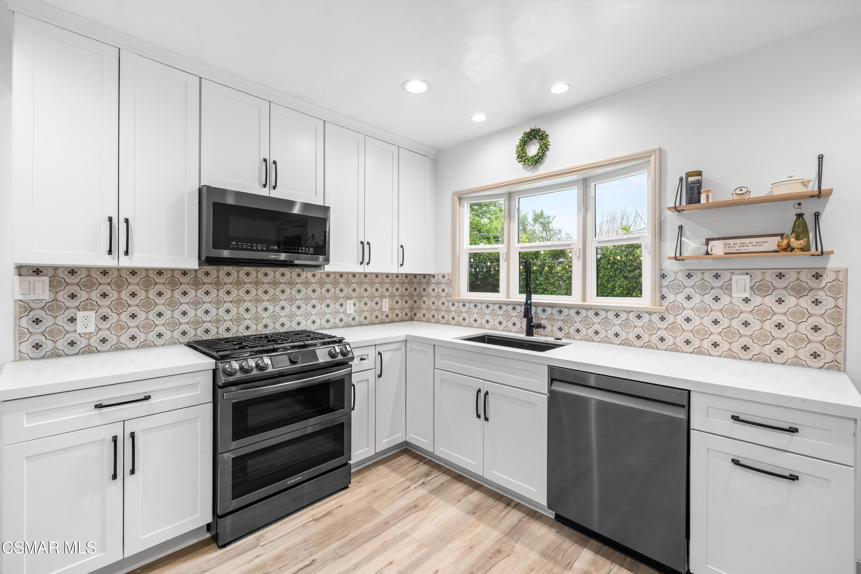 4391 Adam Road Simi Valley, CA 93063 - Photo 14 of 30 a kitchen with a stove a sink and a microwave