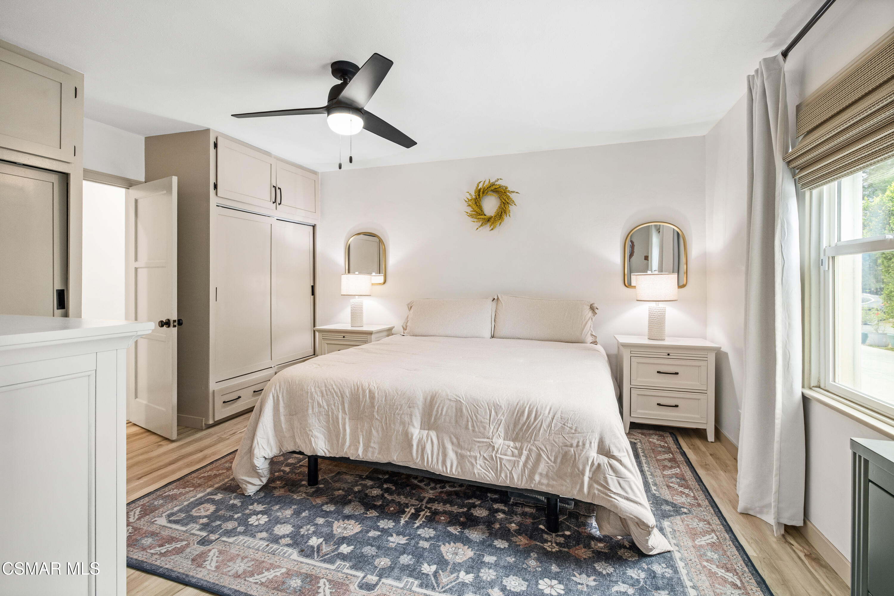 4391 Adam Road Simi Valley, CA 93063 - Photo 16 of 30 a bedroom with a bed and a chandelier