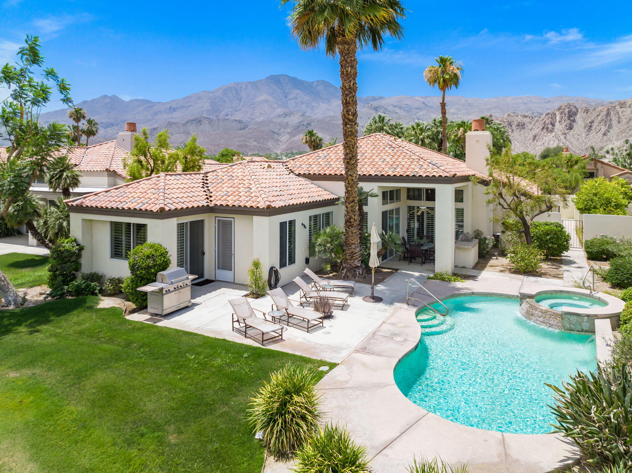 57084 Merion La Quinta, CA 92253 - Photo 1 of 56 a view of a table and chairs under an umbrella