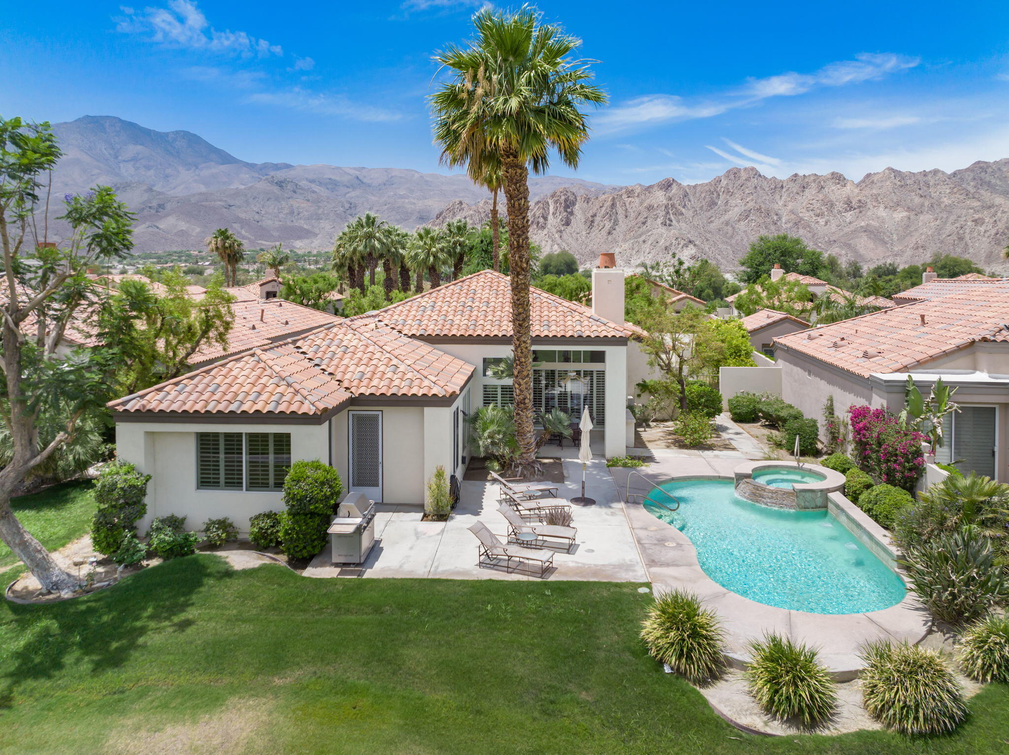 57084 Merion La Quinta, CA 92253 - Photo 11 of 56 a front view of a house with a yard garden and mountain