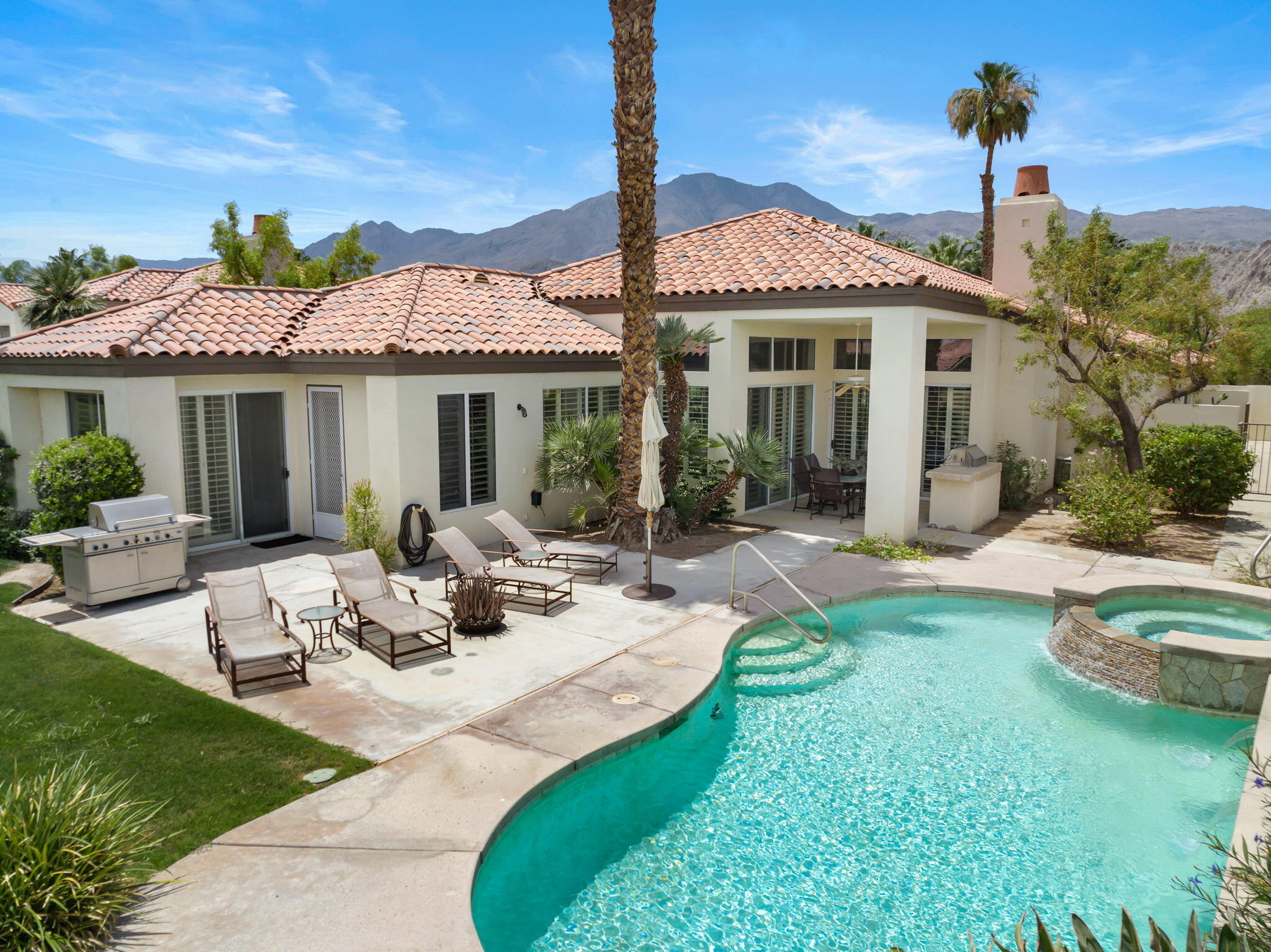 57084 Merion La Quinta, CA 92253 - Photo 13 of 56 a view of a patio with couches table and chairs and potted plants