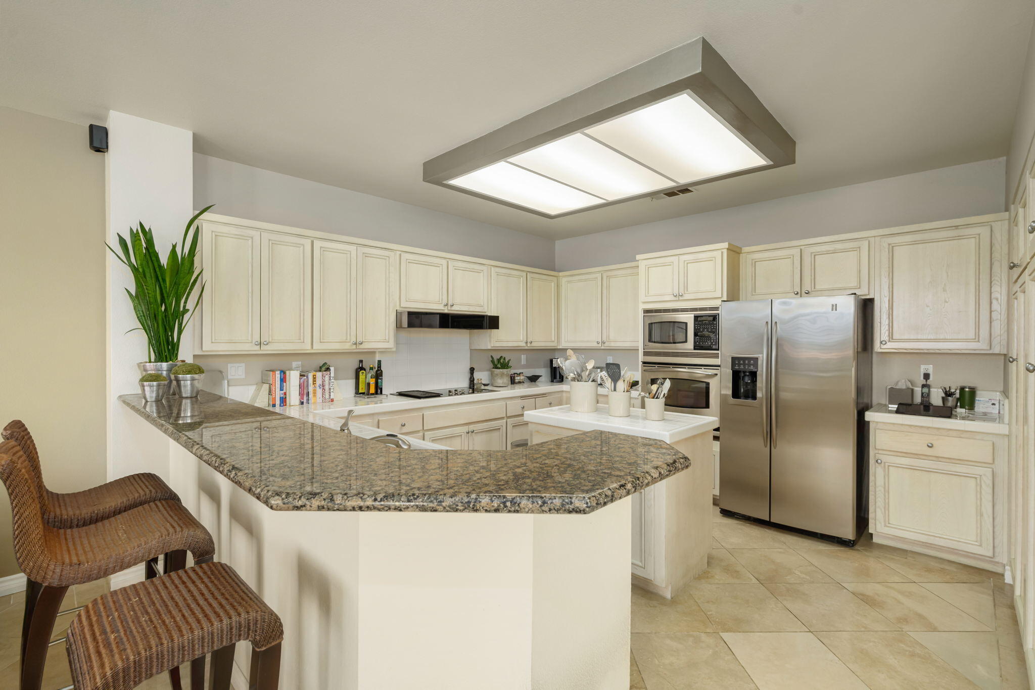 57084 Merion La Quinta, CA 92253 - Photo 34 of 56 a kitchen with stainless steel appliances granite countertop a sink a stove a refrigerator a washer and dryer